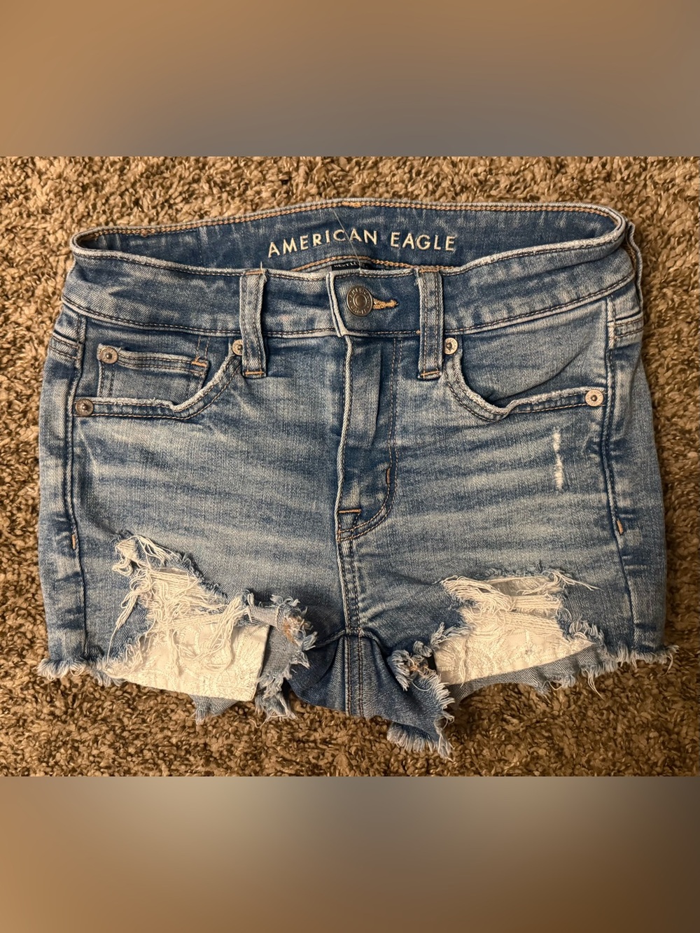 American Eagle High-Rise Light Blue Distressed Denim Shorts with Lace Pockets